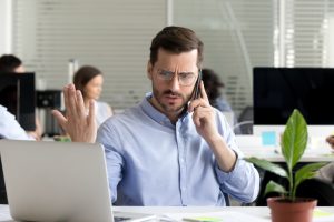 Picture of a man on the phone trying to settle a commercial real estate disagreement or dispute