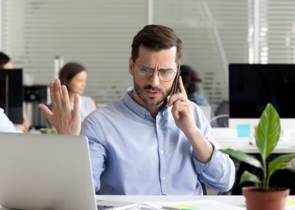 Picture of a man on the phone trying to settle a commercial real estate disagreement or dispute